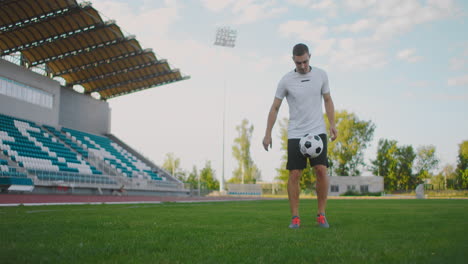 Professional-Male-soccer-player-athlete-on-the-football-field-in-slow-motion-in-sports-equipment-bounce-a-soccer-ball